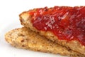 Slice of multi-seed wholegrain bread toasted and buttered with jam. Royalty Free Stock Photo