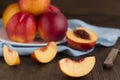 Slice of nectarine and whole fruits on a wooden table. Royalty Free Stock Photo