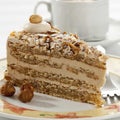 Slice of Noisette Cake with cup of coffee, close up. Royalty Free Stock Photo