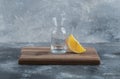 Slice of orange and empty glass on wooden board Royalty Free Stock Photo