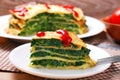 Slice of pancake cake with spinach