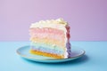 Slice of pastel rainbow colored layered birthday cake with cream in front of pastel violet and blue background Royalty Free Stock Photo