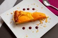 Slice of peach shortcrust custard tart with sliced almonds Royalty Free Stock Photo