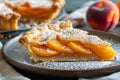 A slice of peach tart on a plate, dusted with icing sugar Royalty Free Stock Photo