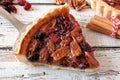 Slice of pecan cranberry pie on pie server