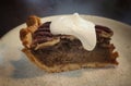 A slice of pecan pie with whipped cream on a white plate,Traditional Thanksgiving individual serving of pecan pie on  table and Royalty Free Stock Photo