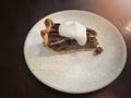 A slice of pecan pie with whipped cream on a white plate,Traditional Thanksgiving individual serving of pecan pie on wooden table