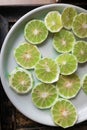 lime in green fresh sliced on white plate. Royalty Free Stock Photo