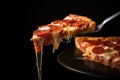 Slice Of Pepperoni Pizza Lifted By Fork On Black Background Royalty Free Stock Photo