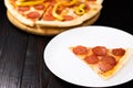 Slice of pepperoni pizza on a white plate Royalty Free Stock Photo