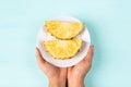 Slice pineapple on white plate and holding by hand Royalty Free Stock Photo