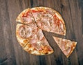 Slice of pizza with ham and cheese on wood table Royalty Free Stock Photo