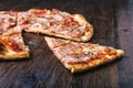 Slice of pizza with ham and cheese on wood table Royalty Free Stock Photo