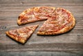 Slice of pizza with ham and cheese on wood table Royalty Free Stock Photo