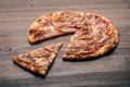 Slice of pizza with ham and cheese on wood table Royalty Free Stock Photo