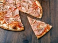 Slice of pizza with ham and cheese on wood table Royalty Free Stock Photo