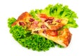 Slice of pizza with salad leaves isolated on white background