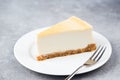 Slice of plain cheesecake on white plate