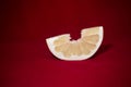 One slice of pomelo on a red table Royalty Free Stock Photo