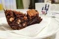 Slice portion of brownie dessert on a saucer.