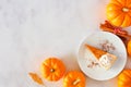 Slice of pumpkin pie cheesecake with whipped cream, top view corner border on a marble background