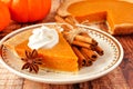 Slice of pumpkin pie, close up on a wood background Royalty Free Stock Photo
