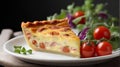 A slice of quiche lorraine with salad and cherry tomatoes on the side