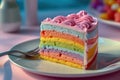 a slice of rainbow cake with a fork