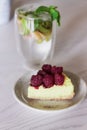 Slice of raspberry cake and non-alcoholic mojito in the cafe. Summer food Royalty Free Stock Photo