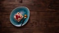 Slice of raspberry pie on a blue plate on a wooden background, free space