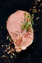 Slice of raw pork loin with the addition of aromatic herbs and spices Royalty Free Stock Photo