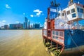 A Slice of Reality boat remains on Thames river and Canary Wharf in London view