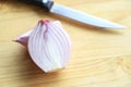 Slice red onion on cutting board for being ingredient in cooking Royalty Free Stock Photo