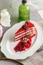 Slice of red velvet cake with raspberries on white plate on the table Royalty Free Stock Photo