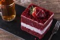 slice of red velvet cake with white frosting is garnished with strawberries close up Royalty Free Stock Photo