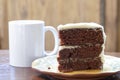 A slice of rich moist 3 layer chocolate cake on a plate Royalty Free Stock Photo