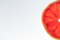 Slice of ripe grapefruit on a white background