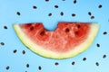 slice of ripe juicy watermelon and seeds on a blue background Royalty Free Stock Photo