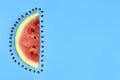 slice of ripe juicy watermelon and seeds on a blue background. Copy space for text Royalty Free Stock Photo