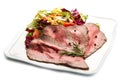 Slice roastbeef on white dish with salad