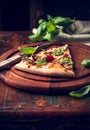 Slice of rustic pizza topped with fresh basil Royalty Free Stock Photo