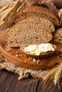 Slice of rye bread with butter on wooden board Royalty Free Stock Photo