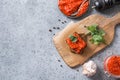Slice of rye bread with ajvar. Vegetable sauce of baked red bell pepper on grey. Balkan cuisine. Space for text. Top view Royalty Free Stock Photo