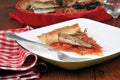 Slice of sardine pie served on a plate with a fork close-up