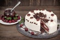 Slice of Schwarzwald cake, delicious creamy fruit and chocolate cake with whipped cream, sour cherry and dark chocolate