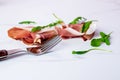 Slice of smoked ham on fork on a white background Royalty Free Stock Photo