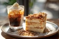 Slice of Spanish Gato de Almendras cake and glass of iced coffee.