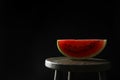 Slice of tasty fresh watermelon on table against black background, space for text Royalty Free Stock Photo