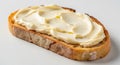 Slice of Toasted Sourdough Bread Generously Spread with Creamy Butter on a White Background Royalty Free Stock Photo