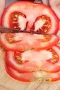 Slice tomato on chopping block